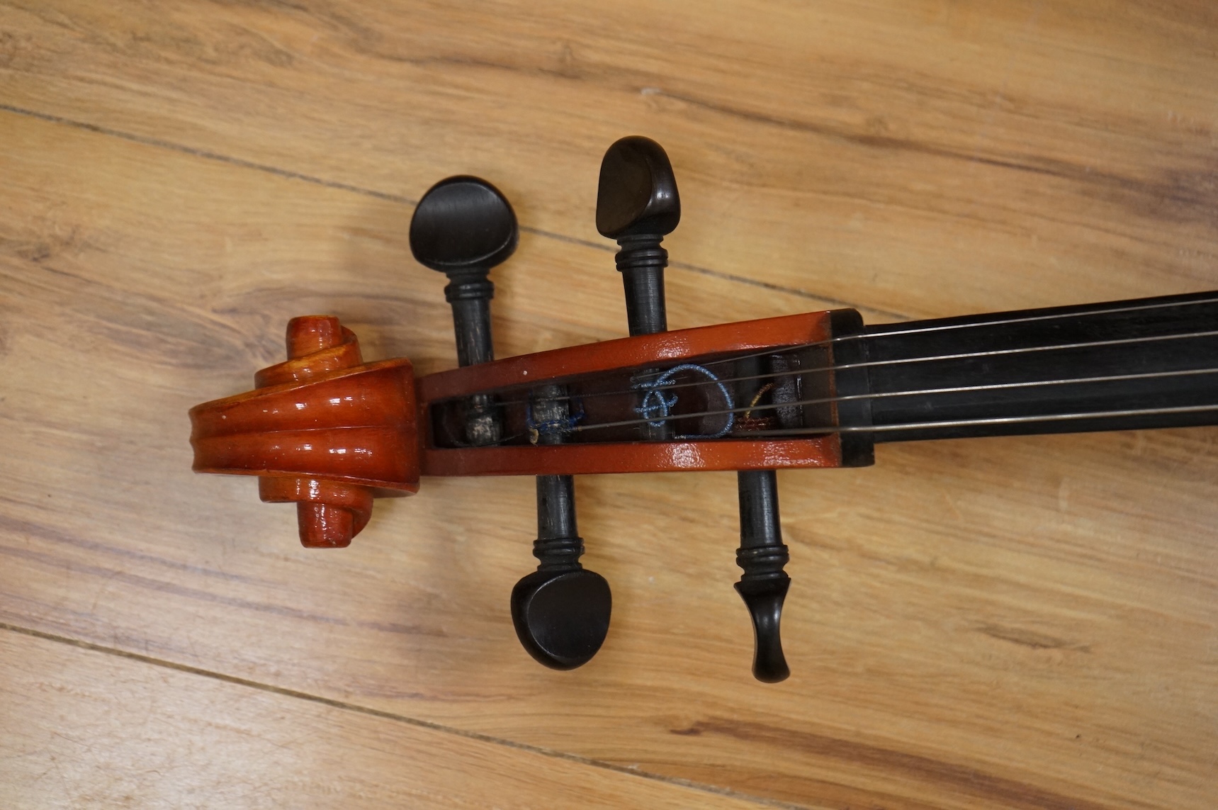 A modern student’s cello in a soft case and a student’s Spanish classical guitar
